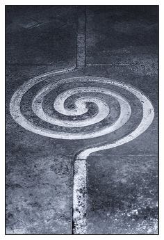 This may contain: an aerial view of a circular object on the ground in black and white, taken from above