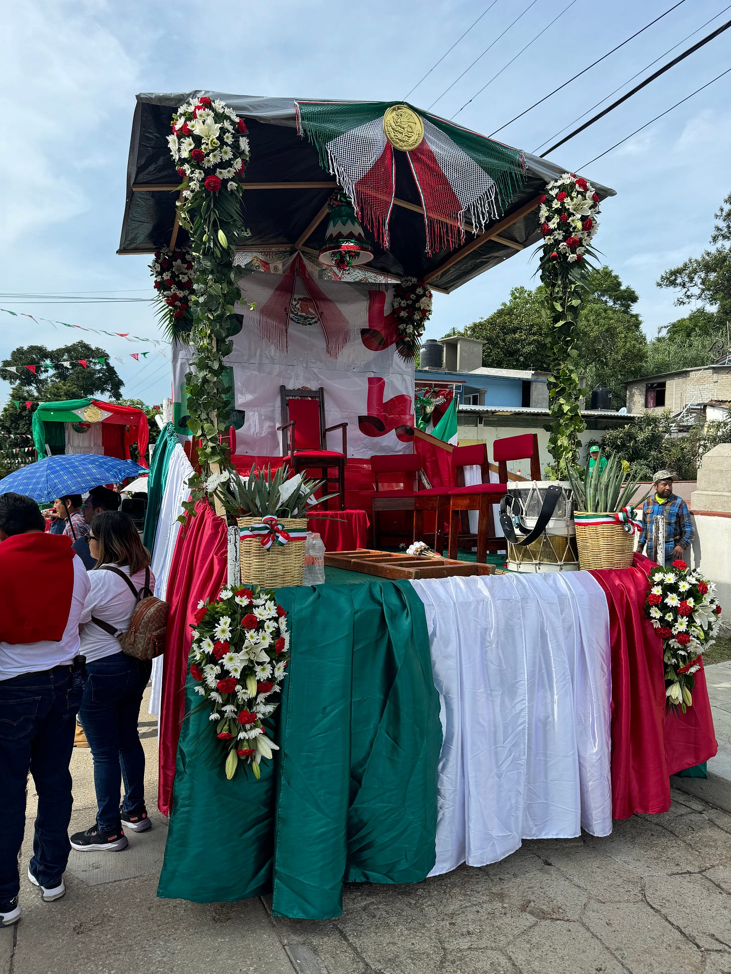 An empty stand covered in Mexican regalia.