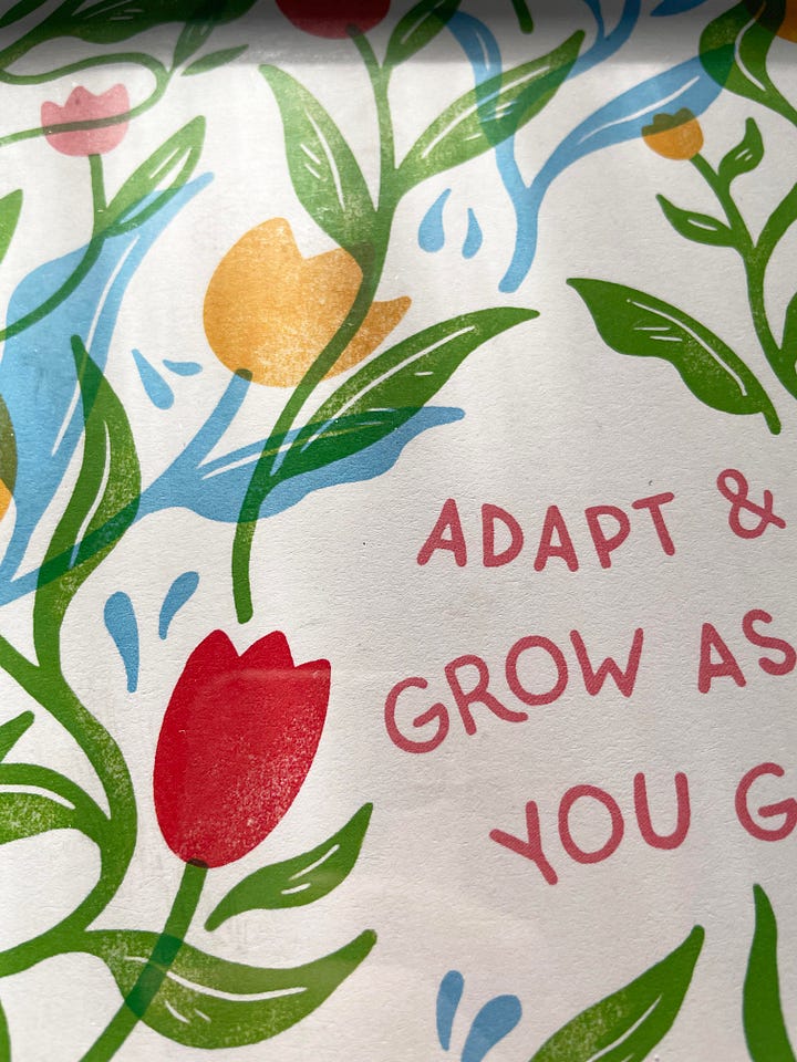 Adapt and grow as you go artwork with handwritten type surrounded by lots of illustrated tulips