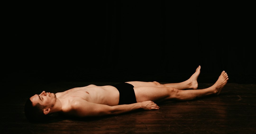 woman in black panty lying on floor