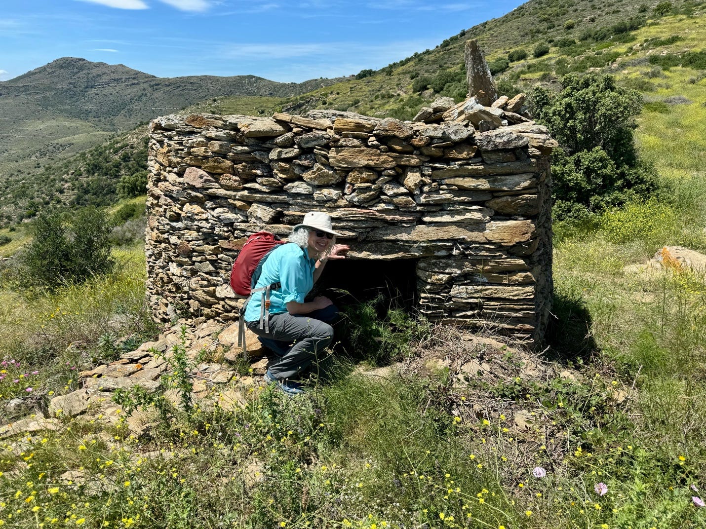 A person sitting in a stone building

Description automatically generated