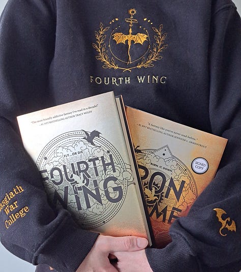 black sweater embroidered with Fourth Wing title and dragon, book, stickers, and signed bookplate for Onyx Storm by Rebecca Yarros
