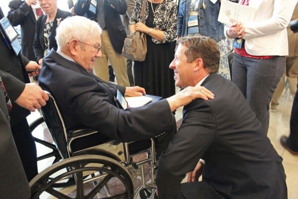 Rep. Adrian Smith greets Congressional Gold Medal recipient Donald McPherson of Adams at the ceremonies in 2015. (Beatrice Daily Sun via AP)