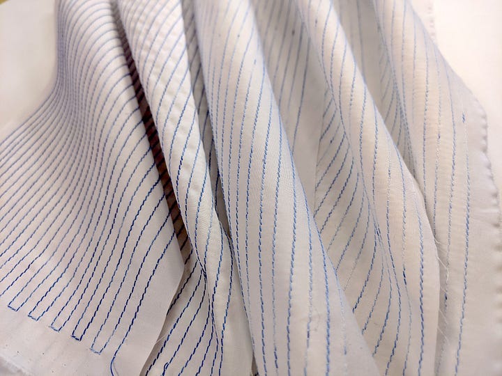 a spool of light blue variegated thread and stitched lines