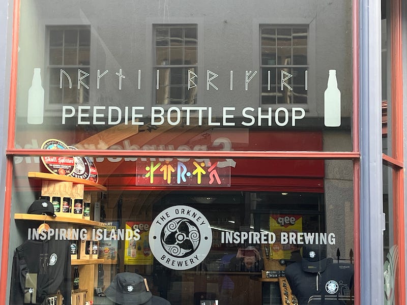 2025-6-26 Shop window for a peedie bottle shop in Kirkwall, photo by author