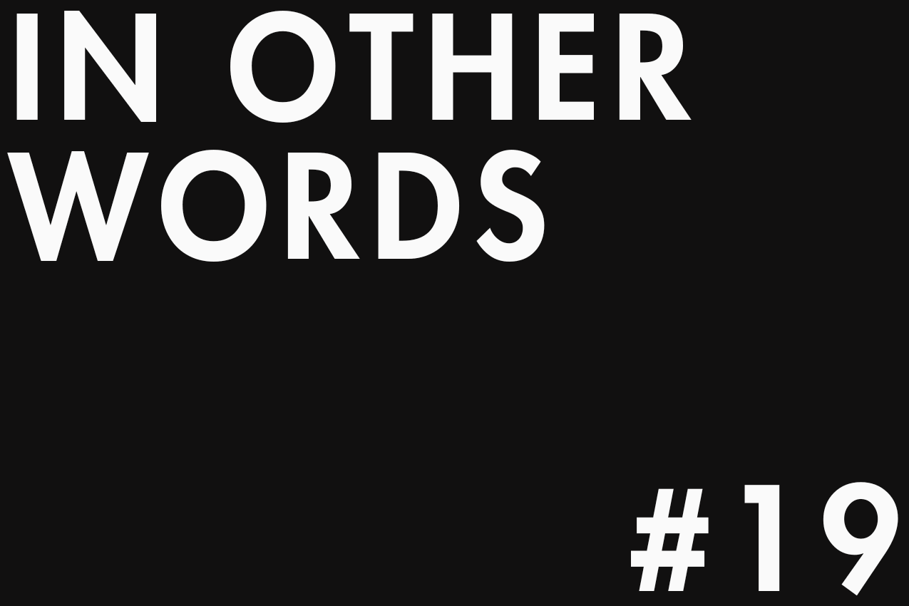 Minimalist typographic image featuring "IN OTHER WORDS" in the top-left corner and "#19" in the bottom-right one. The two elements are separated by negative space in a gallery-style layout. Part of the In Other Words series at The Subtext Review.