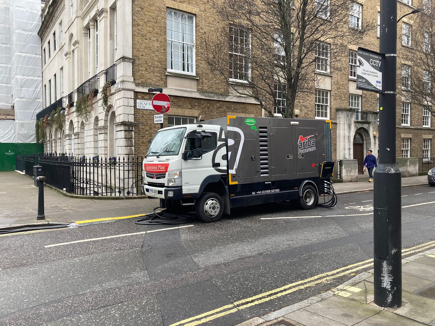Diesel generator truck parked on no loading and double yellow lines in a cycle lane and next to a dropped kerb crossing. Diesel generator truck parked on no loading and double yellow lines in a cycle lane and next to a dropped kerb crossing.