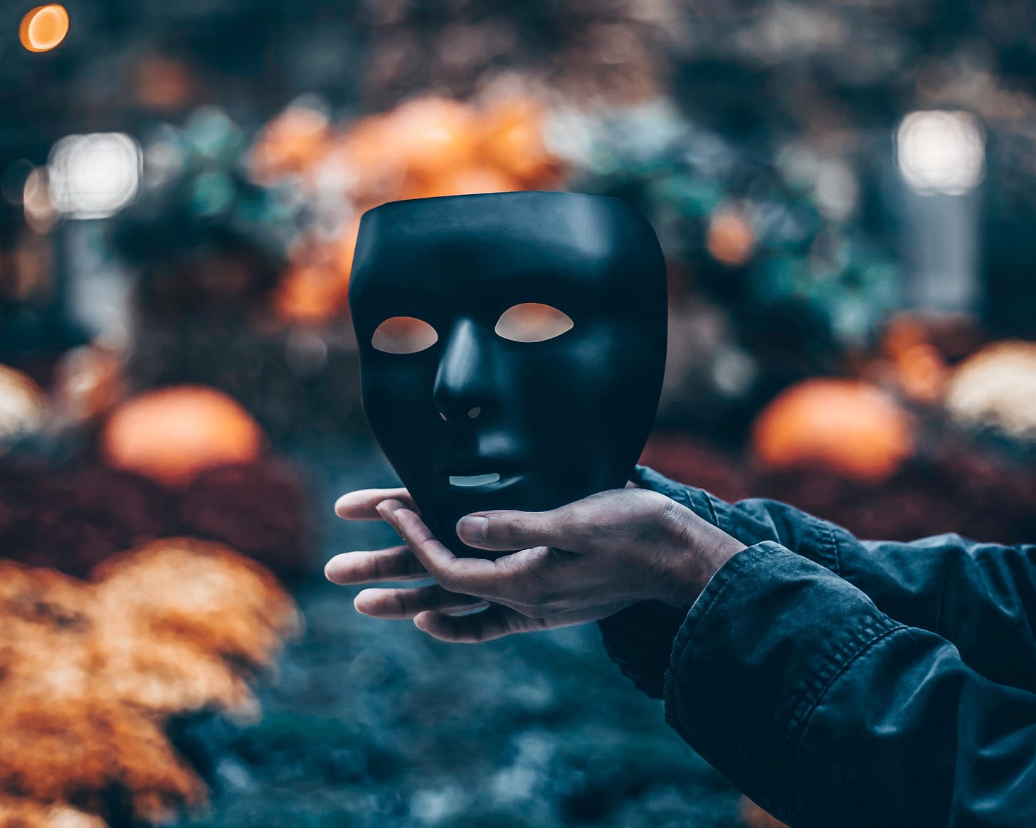 Hands holding black mask Hands holding black mask