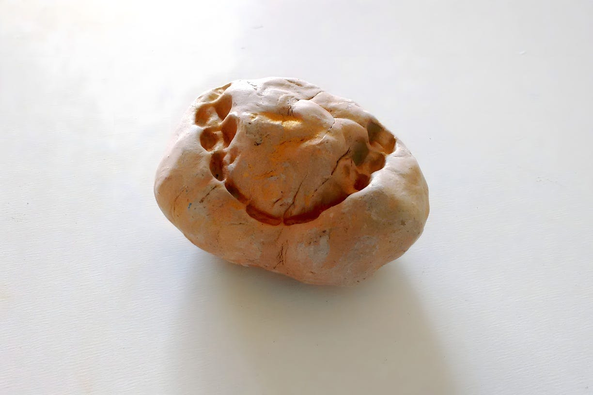 A photo of an art object shows a set of teeth marks in a ball of uncertain material, maybe soft but probably hard.