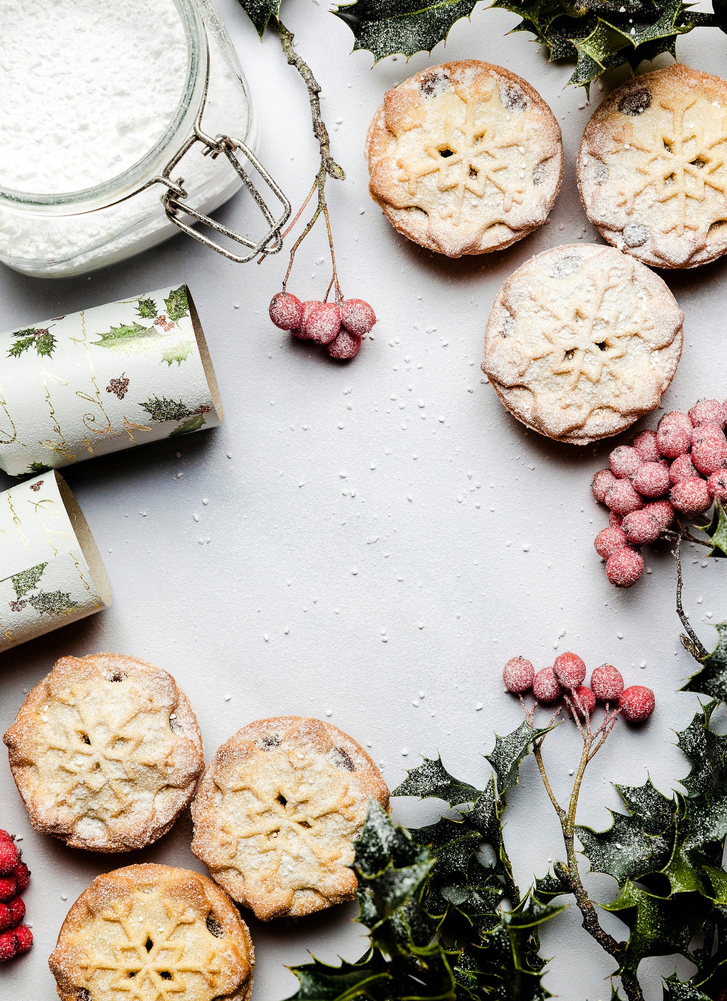 cookies on white counter with holly berries
