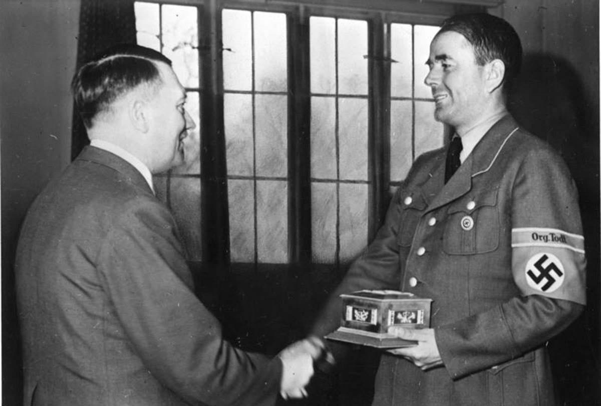 Adolf Hitler presenting an award to Albert Speer between March and June 1943, recognizing his wartime contributions. Adolf Hitler presenting an award to Albert Speer between March and June 1943, recognizing his wartime contributions.