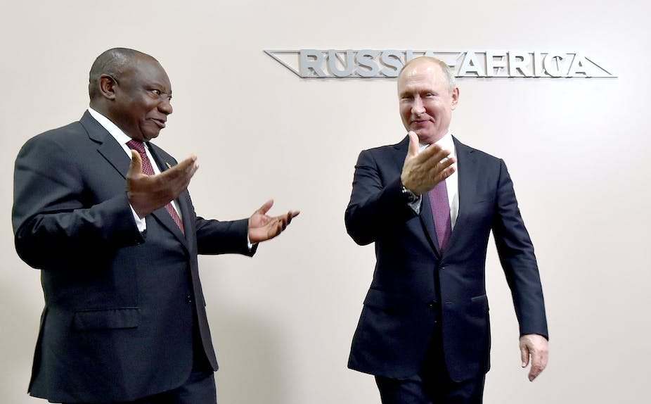 A man, right, points the way with his right hand to another, who has both hands in a surprised gesture. A man, right, points the way with his right hand to another, who has both hands in a surprised gesture.