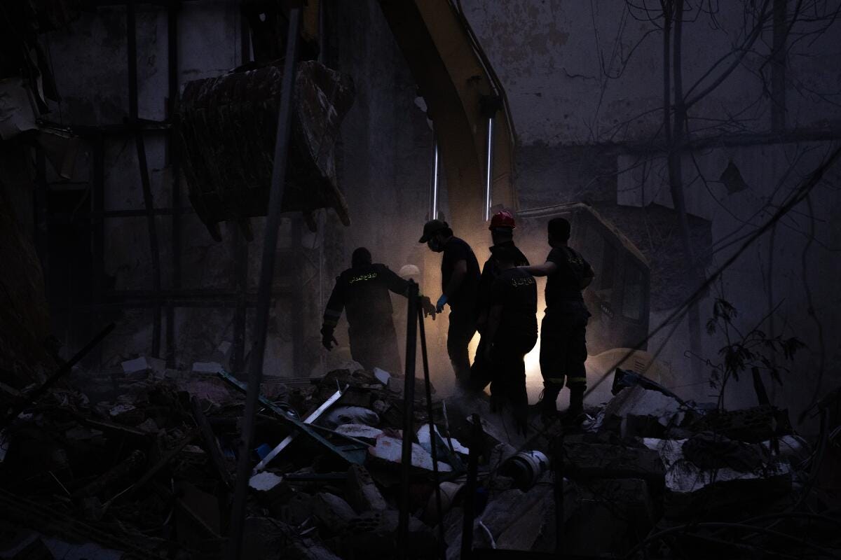 Rescue workers search the rubble for people buried after an Israeli attack