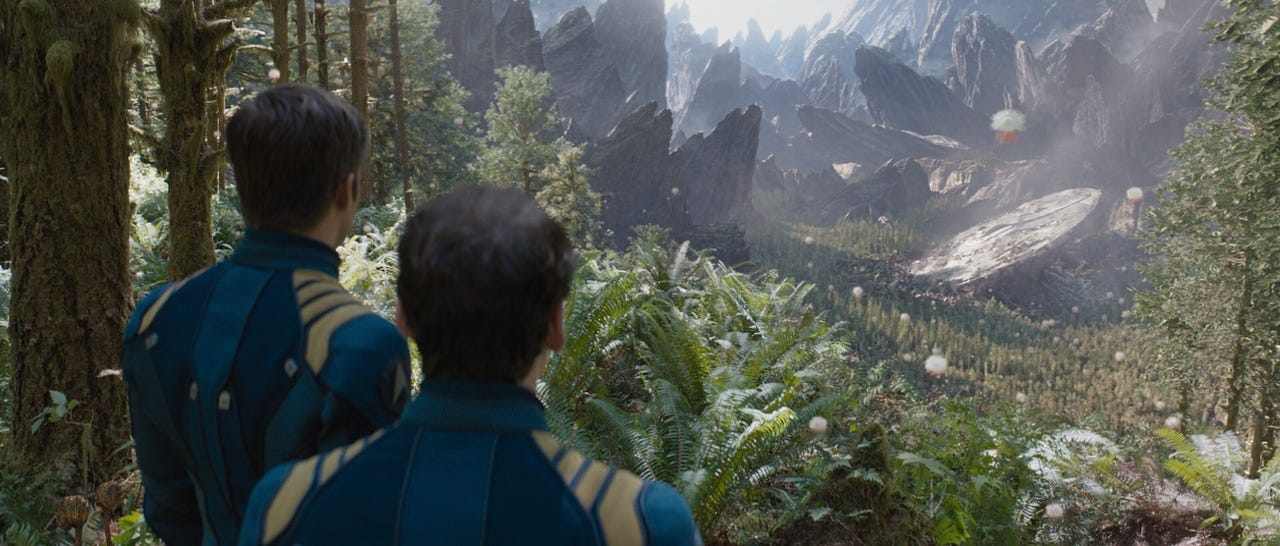 A person looking at a mountain range

Description automatically generated