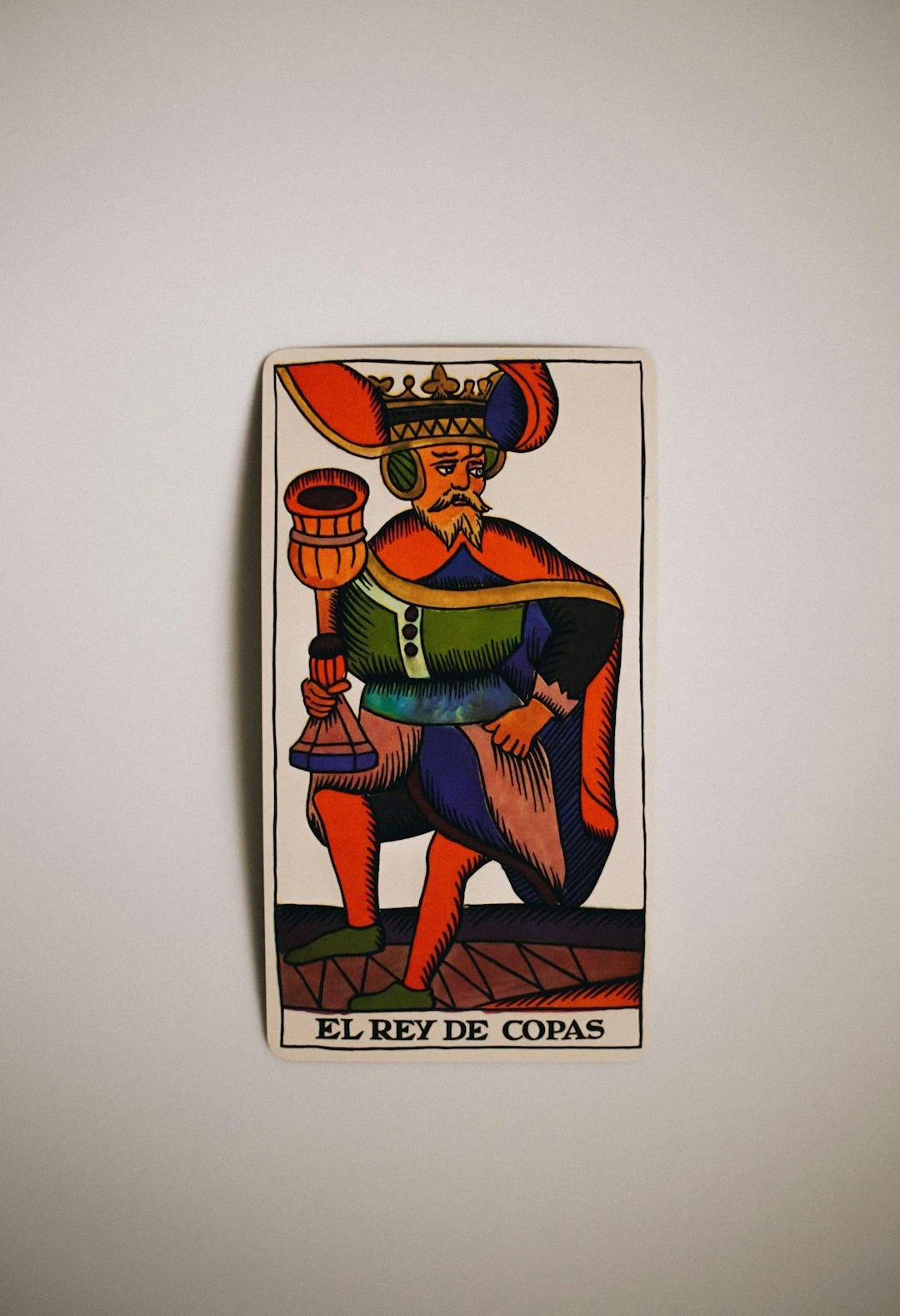 a picture of a king of cups on a wall a picture of a king of cups on a wall