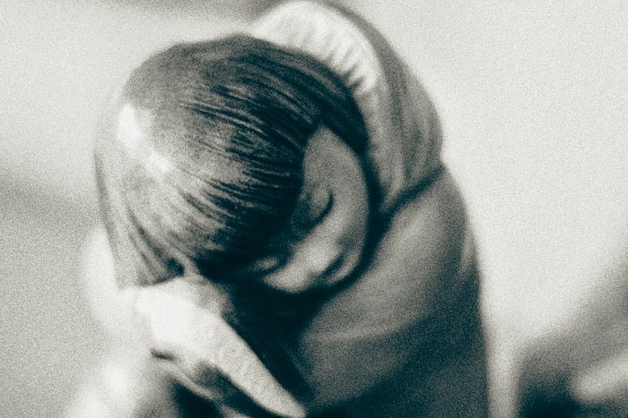 Still life, black and white photography of a statue: a huddled child. Still life, black and white photography of a statue: a huddled child.
