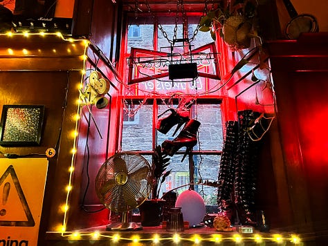 A gallery of images from inside the Star Bar, showing the random array of memorabilia on the walls, sofas and wingback chairs and a windowsill with objects insulting high heeled boots and an empty vase.