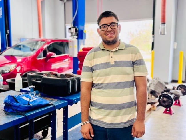 A person standing in a garageAI-generated content may be incorrect. A person standing in a garageAI-generated content may be incorrect.