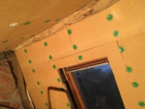 Beautifully lined sloping attic ceiling in wood wool, secured with wide plastic washers