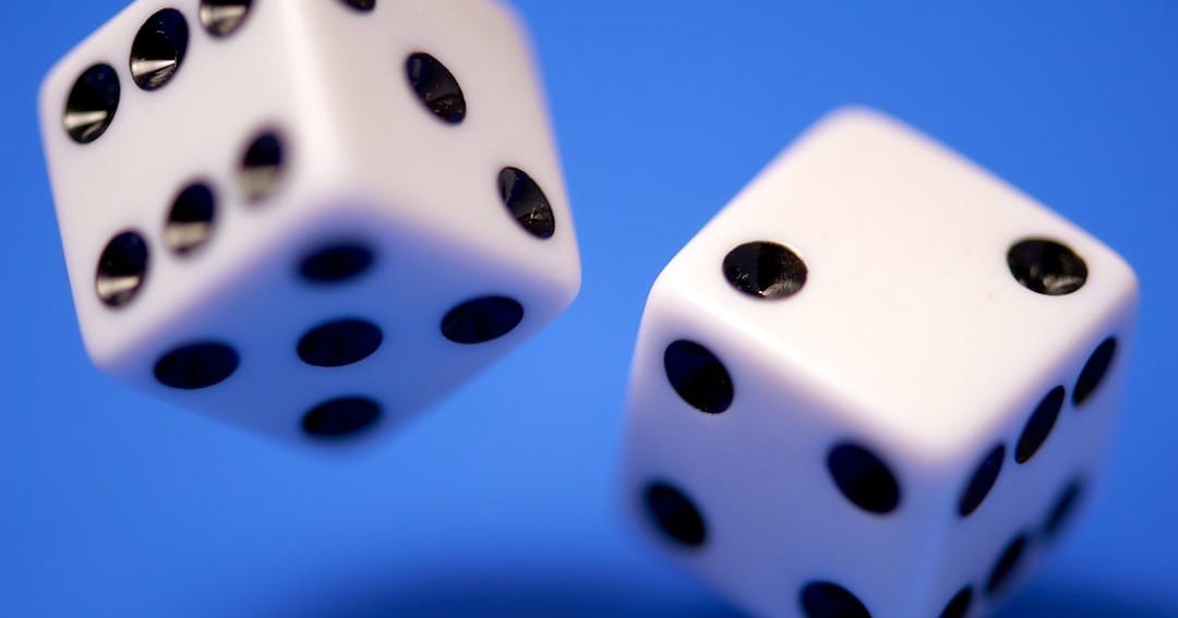 2 white dices on blue surface 2 white dices on blue surface