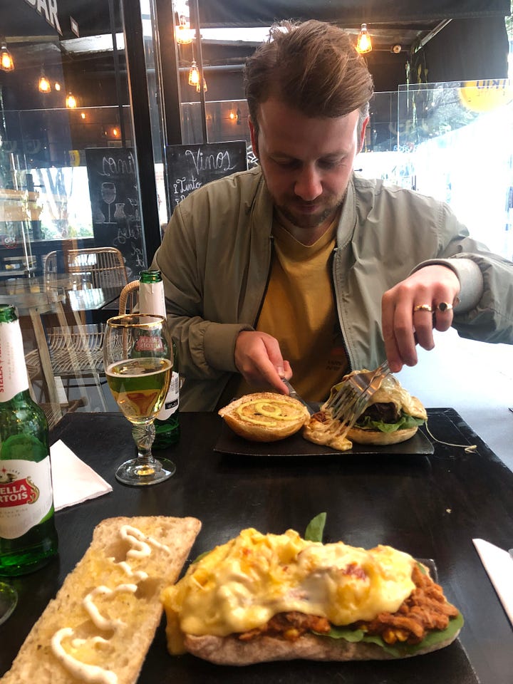 Photo of Harry enjoying the Club Colombia beer tent and photo of Harry enjoying a Stella with his raclette burger
