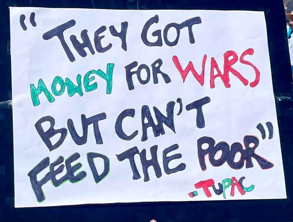 May be an image of money and text that says '" "THY GOT MONEY FOR WARS BUT AN' POOR" FEED FEEDTHE THE TUPK' May be an image of money and text that says '" "THY GOT MONEY FOR WARS BUT AN' POOR" FEED FEEDTHE THE TUPK'