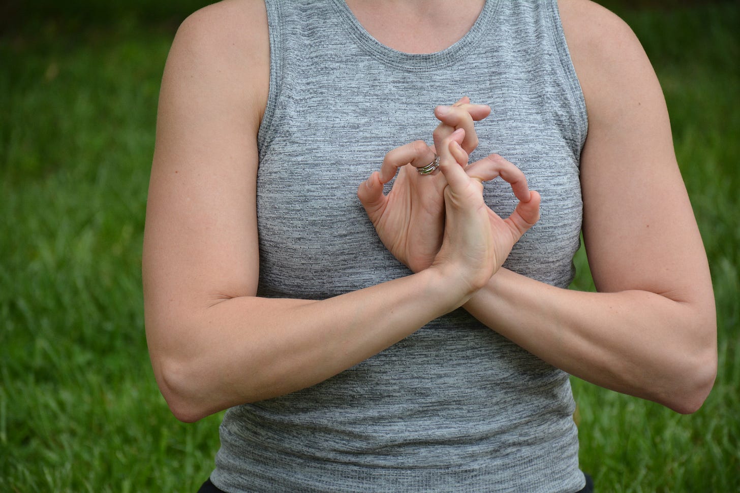 A yogi with hands crossed and fingers woven in front of chest in Abhaya Hridaya Mudra "fearless heart seal" A yogi with hands crossed and fingers woven in front of chest in Abhaya Hridaya Mudra "fearless heart seal"