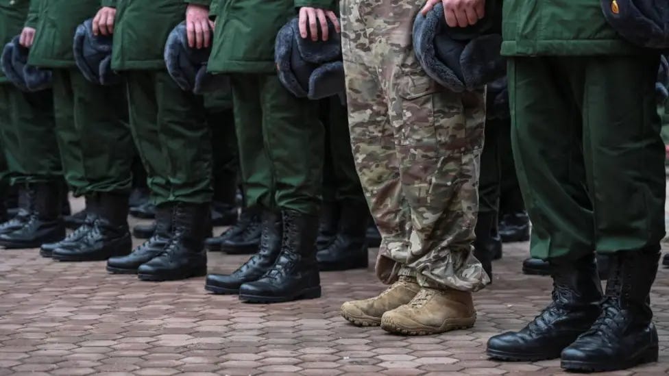 File picture showing a row of Russian army recruits in Rostov region - mostly in dark green uniform, and one in camouflage