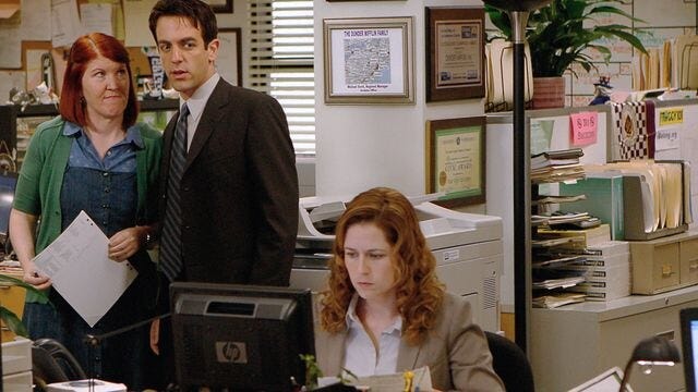 Scene from The Office with Meredith and Ryan whispering behind Pam, depicting classic workplace gossip in a busy office environment. Scene from The Office with Meredith and Ryan whispering behind Pam, depicting classic workplace gossip in a busy office environment.