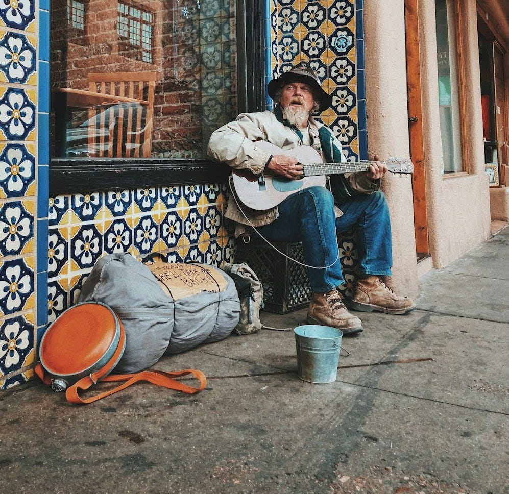 man playing guitar on street man playing guitar on street