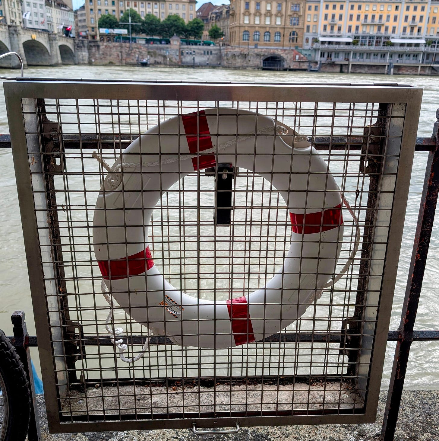 White life saver ring attached to a gate along the banks of the Rhine River in Basel, Switzerland