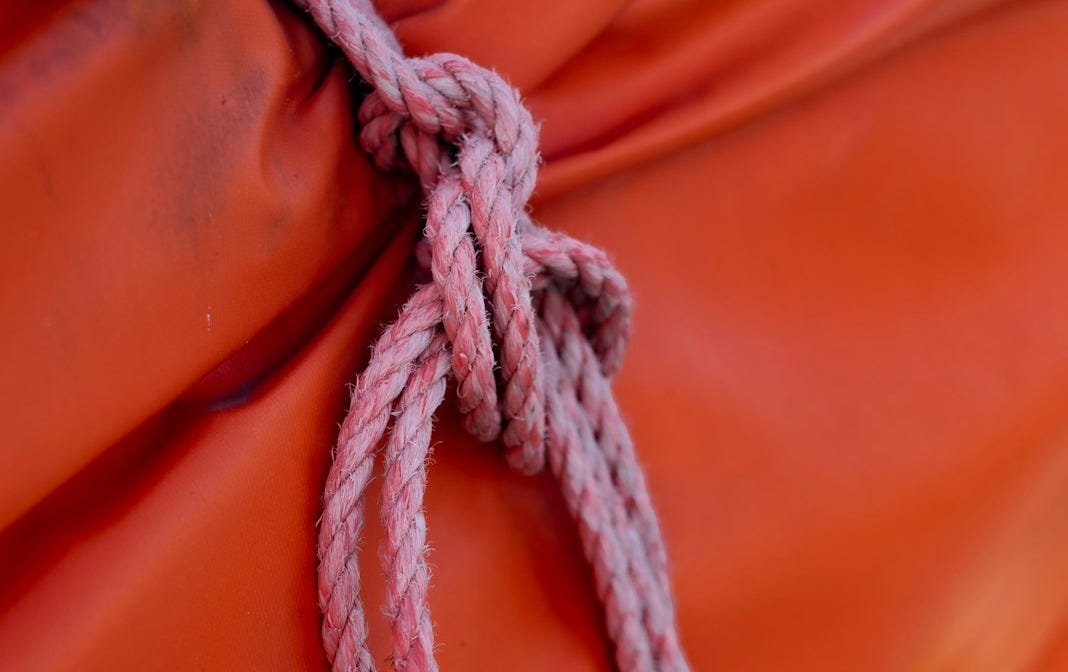 a knot is tied to a red cloth