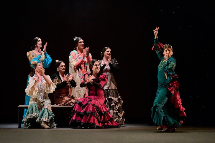 Drag flamenco performers in costume on stage Drag flamenco performers in costume on stage