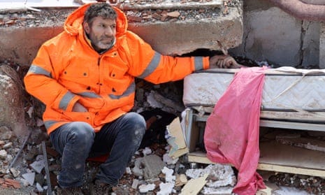 Mesut Hancer holds the hand of his 15-year-old daughter Irmak, who died in the earthquake in Kahramanmaras.