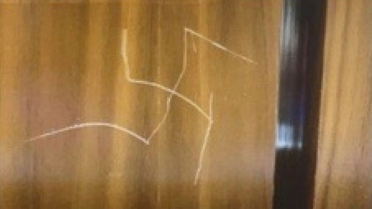 A swastika is seen etched into the wall of a State Department elevator.
