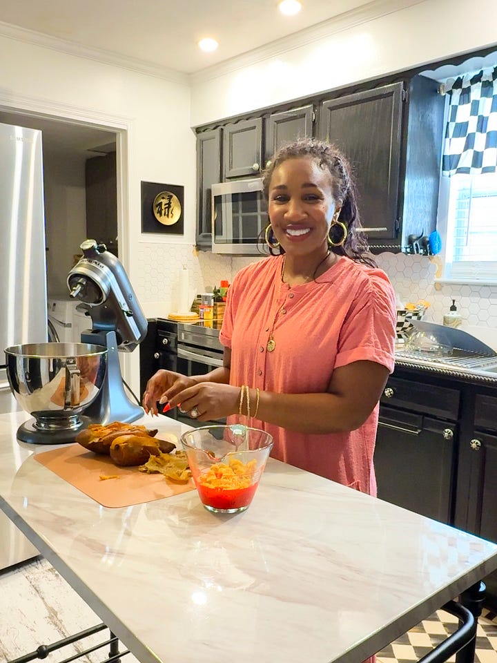Behind-the-scenes of The Soul Food Pot® cookbook photoshoot showing Shaunda Necole mixing ingredients in a home kitchen while being filmed, capturing modern soul food recipe creation and storytelling