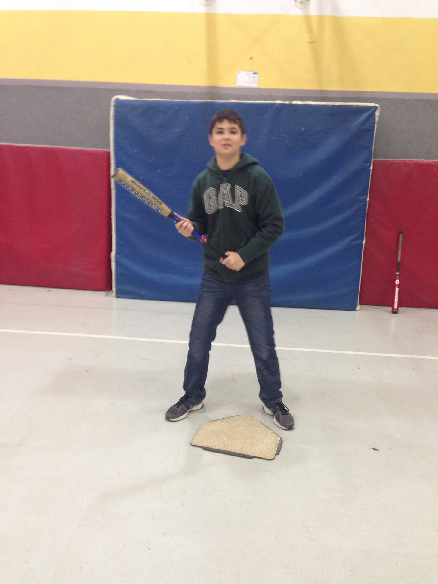 This young man demonstrates the classic Israeli batting stance, hands apart, on home plate, facing the pitcher.