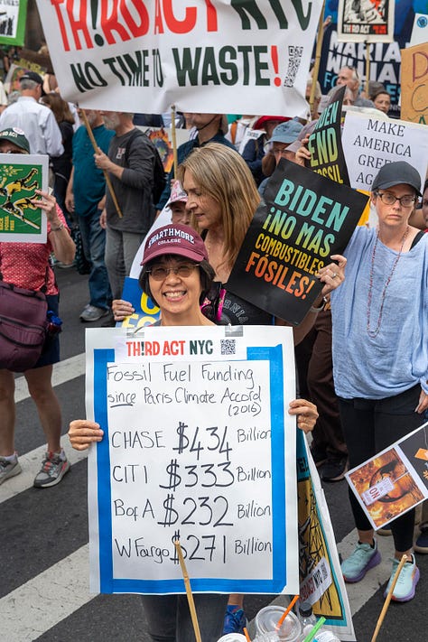 Six photos showing closeups of marchers with various banners and signs