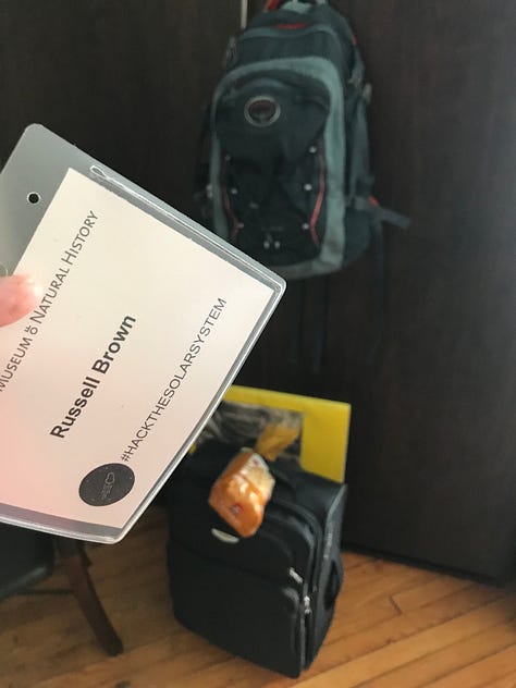 Photographs from a software engineer's overnight sleepover during a hackathon. It includes images of the museum empty at night, the team working together and a photo of earth projected on a screen.