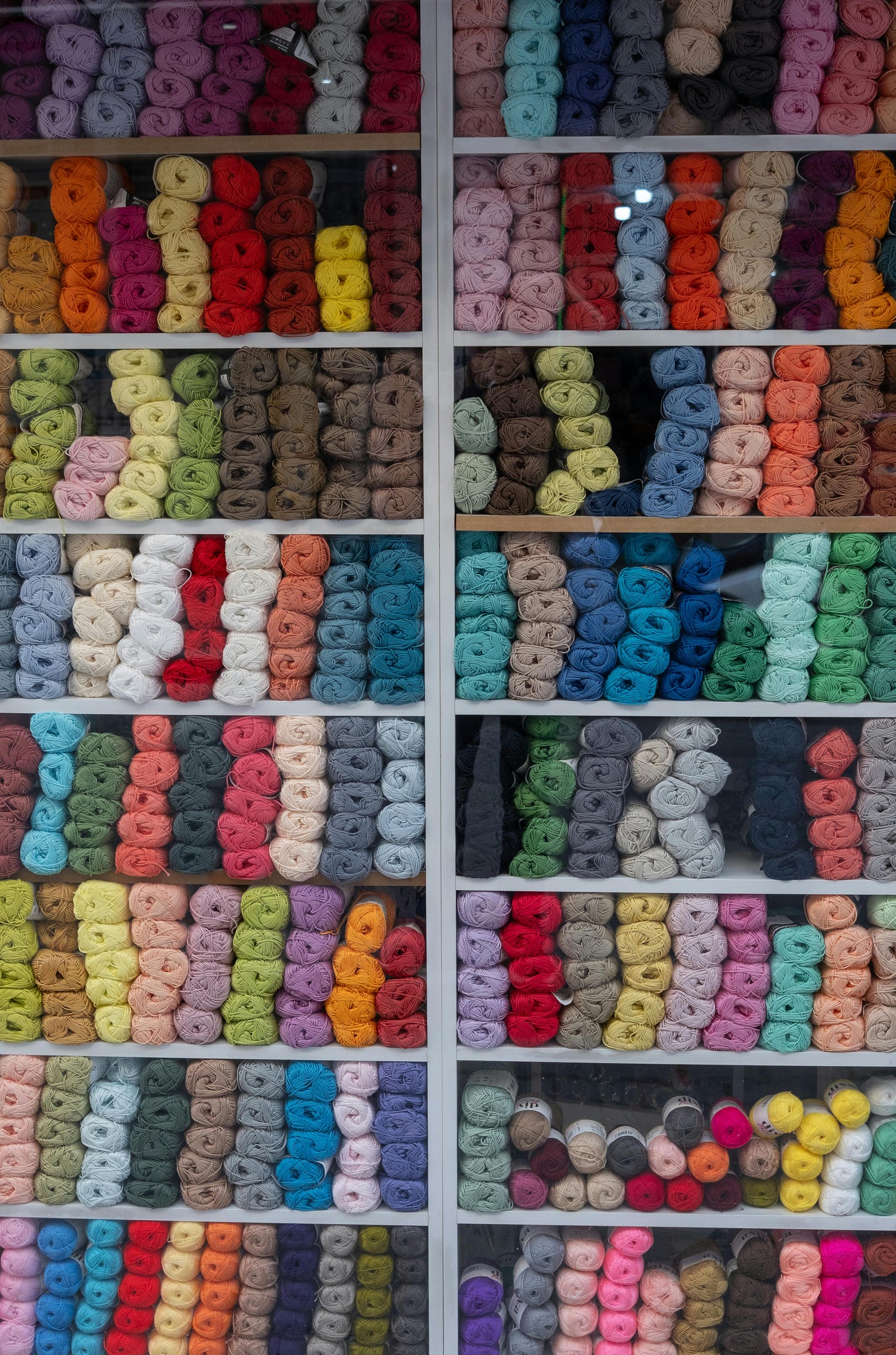 Credit: https://www.pexels.com/@izafi/ Well organised shelves of balls of yarn in many different colours