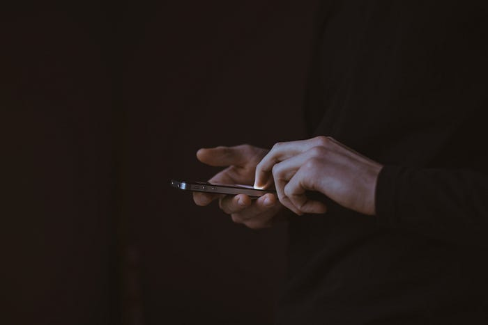 Person holding iPhone Person holding iPhone