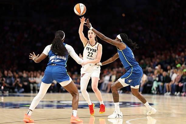 Caitlin Clark of the Indiana Fever passes the ball against Maya Caldwell and Natasha Howard of the Minnesota Lynx quarter at Target Center on... Caitlin Clark of the Indiana Fever passes the ball against Maya Caldwell and Natasha Howard of the Minnesota Lynx quarter at Target Center on...