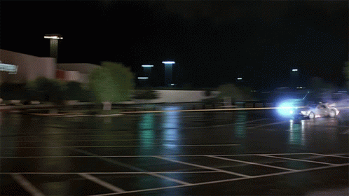 a car is driving through a parking lot with a store in the background a car is driving through a parking lot with a store in the background