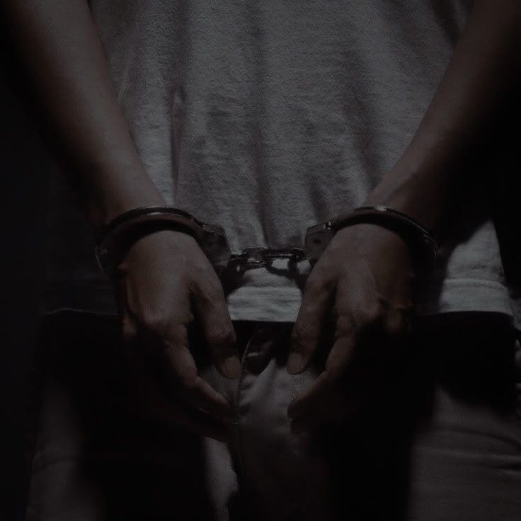 This may contain: a man with his hands in handcuffs