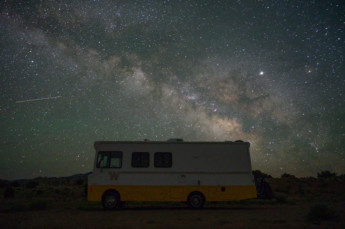 Free Stunning night view of an RV silhouetted against the Milky Way in Utah's desert skies. Stock Photo