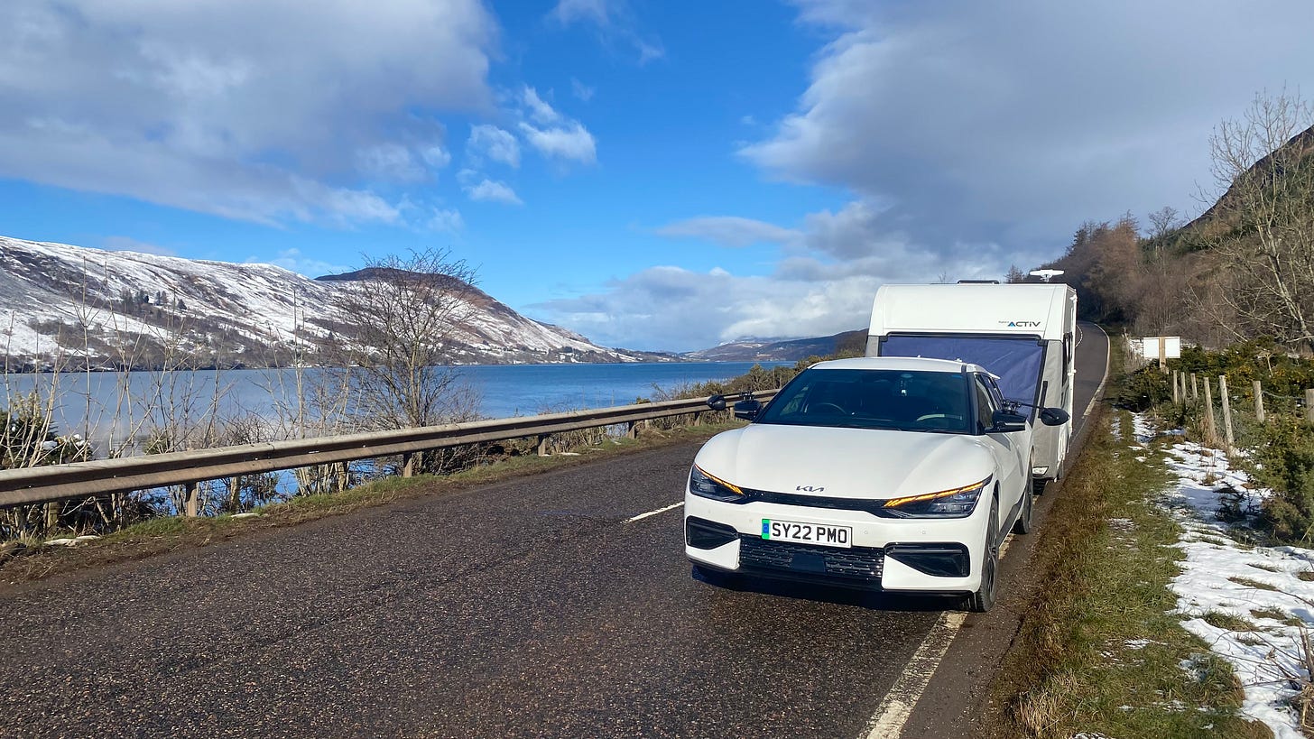 Kia EV6 towing a caravan in the Scottish Highlands