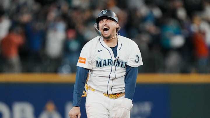 Oct 17, 2025; Seattle, Washington, USA; Seattle Mariners first baseman Josh Naylor (12) reacts after third baseman Eugenio Suarez (not pictured) hits a grand slam against the Toronto Blue Jays in the eighth inning during game five of the ALCS round for the 2025 MLB playoffs at T-Mobile Park. Mandatory Credit: Stephen Brashear-Imagn Images Oct 17, 2025; Seattle, Washington, USA; Seattle Mariners first baseman Josh Naylor (12) reacts after third baseman Eugenio Suarez (not pictured) hits a grand slam against the Toronto Blue Jays in the eighth inning during game five of the ALCS round for the 2025 MLB playoffs at T-Mobile Park. Mandatory Credit: Stephen Brashear-Imagn Images