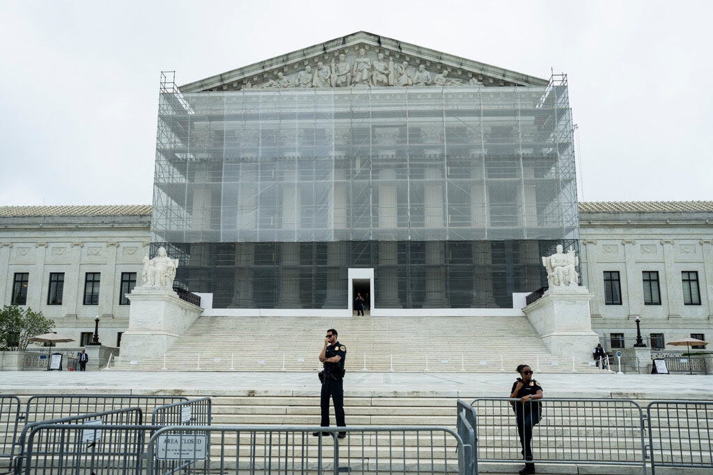 A view of the Supreme Court building, covered by scaffolding.