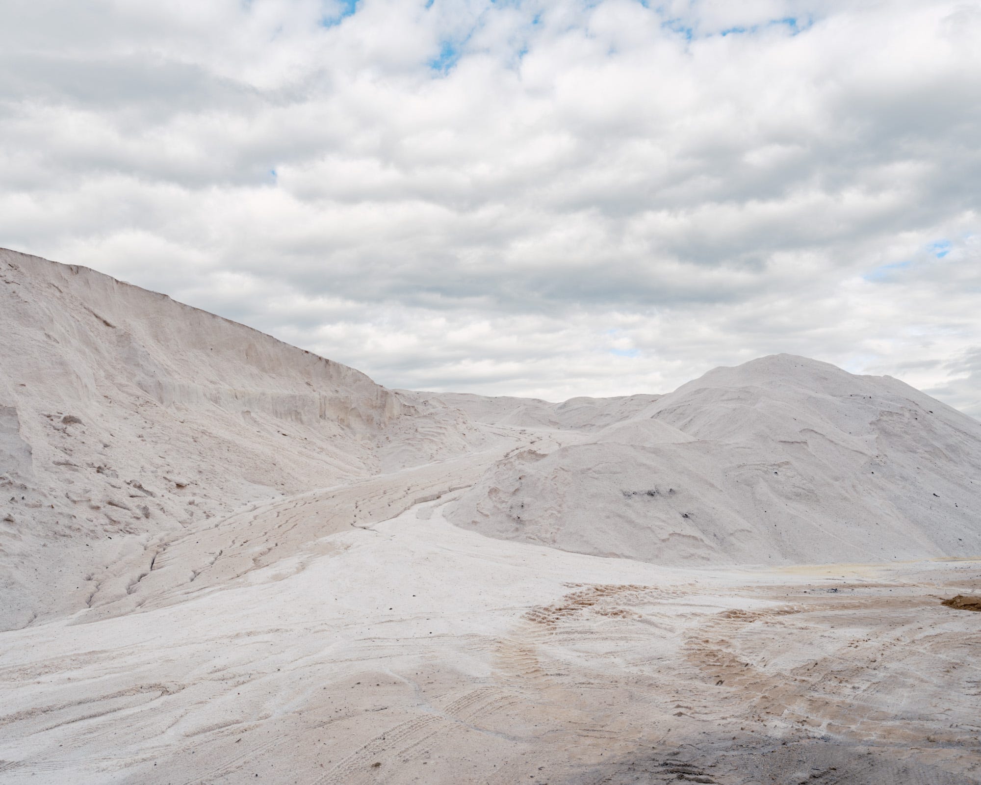Mountains-Of-White-Sand-Under-A-Puffy-Cloud-Filled-Sky