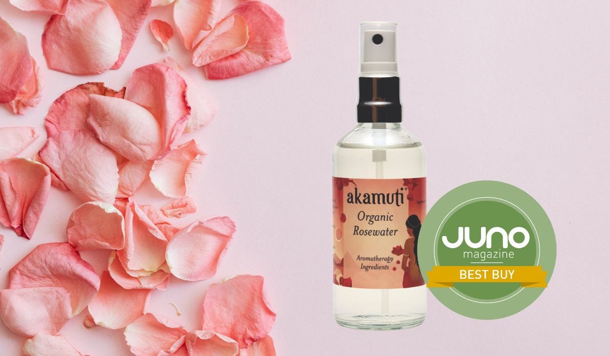 A bottle of Akamuti's Organic Rosewater against a background of pale pink rose petals